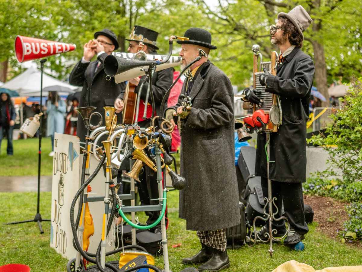 Steampunk performers with a whimsical mechanical music contraption at a Waltham community festival